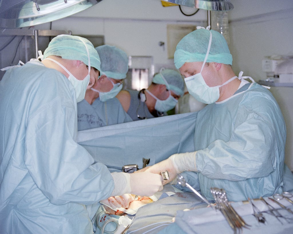 Surgeons performing appendectomy on a patient in the operating room